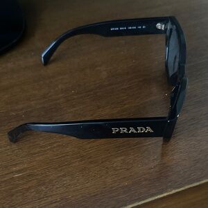 Prada Elegant Black Sunglasses with Gold Detail